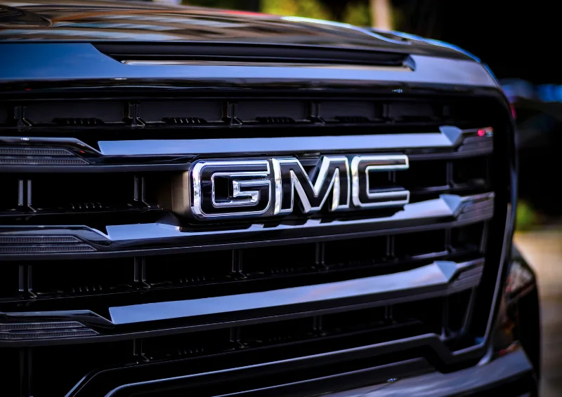 Front grille of GMC truck featuring chrome badge and accents