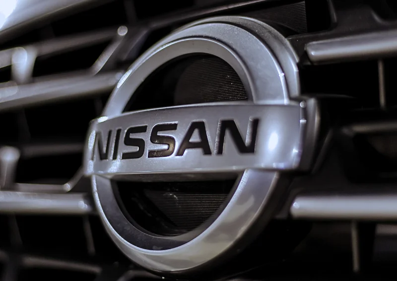 Nissan emblem centered on front grille with black and silver trim