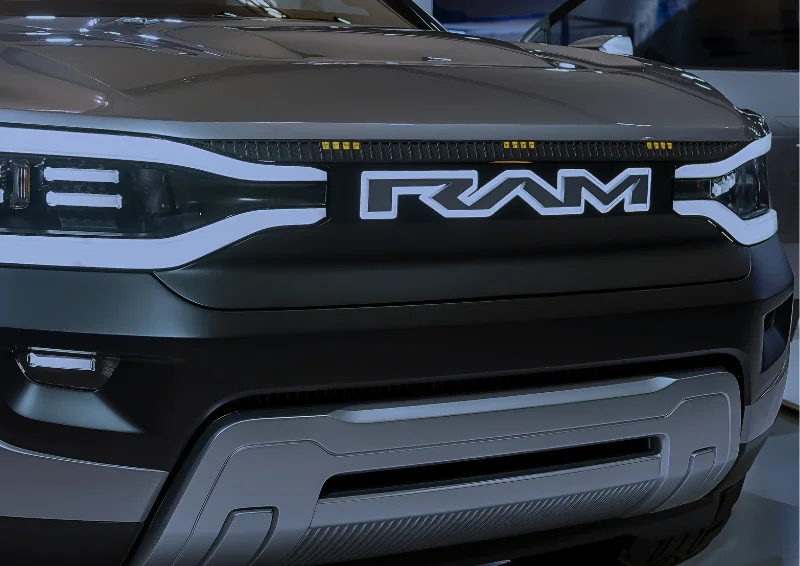 Front of RAM truck with large illuminated badge and modern LED lights