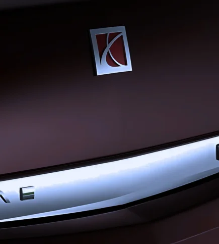 Close-up of red Saturn emblem on dark vehicle trunk