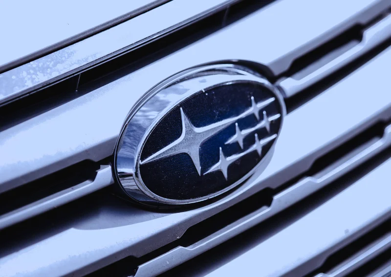 Subaru badge on silver grille with six-star constellation design