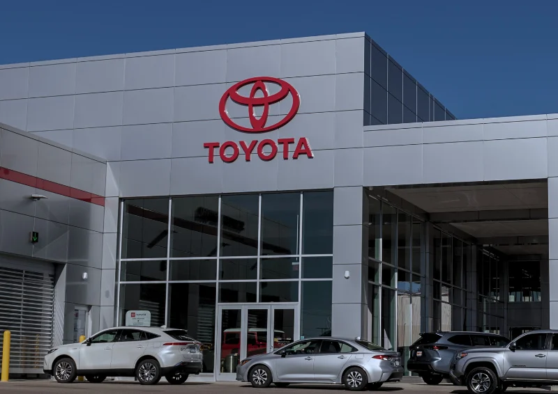 Exterior view of Toyota dealership building with cars parked outside